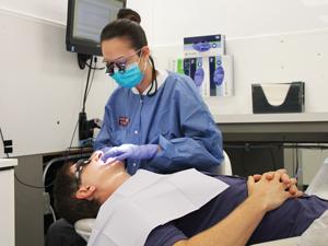 Dental Hygiene student cleaning a patient